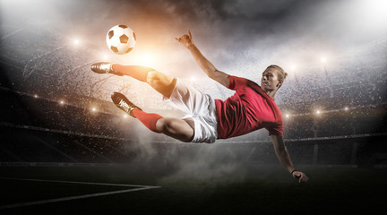 Soccer player in action on stadium background.