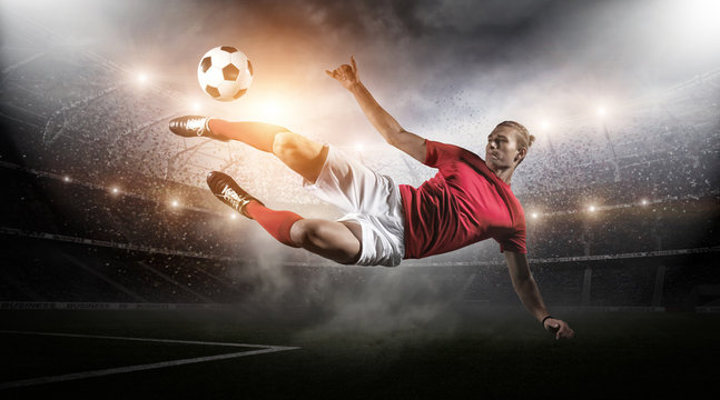 Fototapeta Soccer player in action on stadium background.