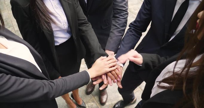 A group of business people from different ethnic backgrounds rejoices and celebrates their success in the financial and economic fields. Concept of: team work, internationality and success.