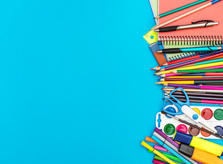 Frame from school supplies on blue background. Education background.