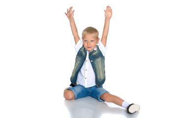 little boy is sitting on the floor