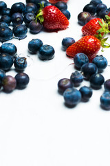 isolated strawberries and blueberries on a white background