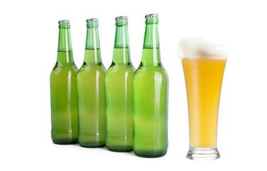 Four Green Beer Bottles and One Full Glass of Beer on a white background. 