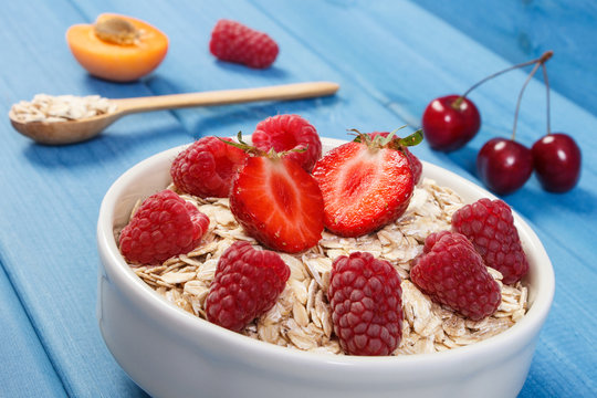 Oat flakes or oatmeal with strawberries and raspberries, healthy lifestyle and nutrition