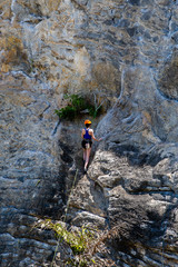 Rock climber climbing on Railay beach in Krabi, Thailand.