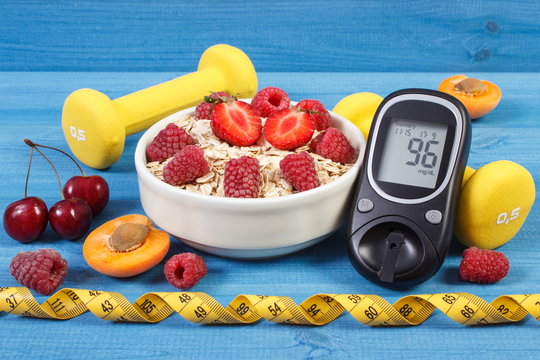 Glucometer for checking sugar level, oat flakes with fruits, dumbbells and centimeter, concept of diabetes and healthy lifestyle