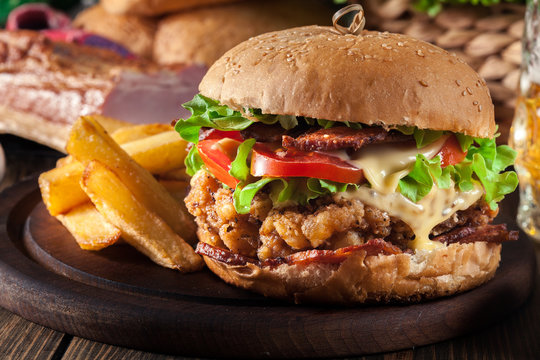 Chickenburger with bacon, tomato, cheese and lettuce