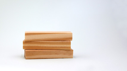 A pile of three wooden blocks.