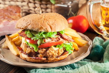 Chickenburger with bacon, tomato, cheese and lettuce