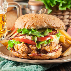 Chickenburger with bacon, tomato, cheese and lettuce
