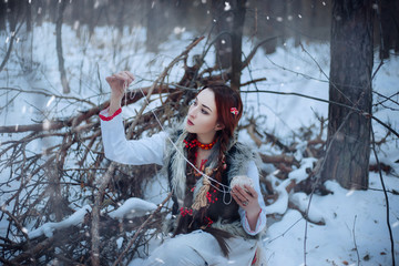  Beautiful girl with long braids in a winter forest. A witch from a fairy tale. fantasy Photo