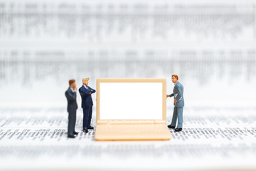Miniature people: Businessman thinking with project for presenting investment on White screen computer laptop , Business and technology concept