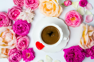 Colorful roses with cup of coffee