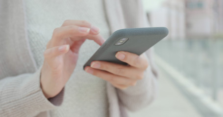 Close up of using smart phone in city