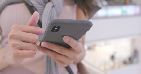 Woman use of mobile phone in shopping mall