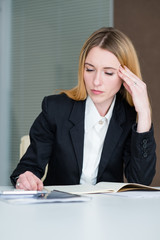 headache stress tiredness concept. young business lady at work