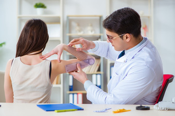 Doctor checking patients joint flexibility with gonimeter