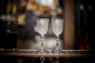 Two elegant cooled glasses arranged on the bar counter