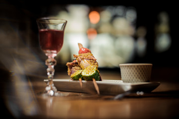 Elegant glass filled with tasty Arnaud cocktail with a plate of tasty dish