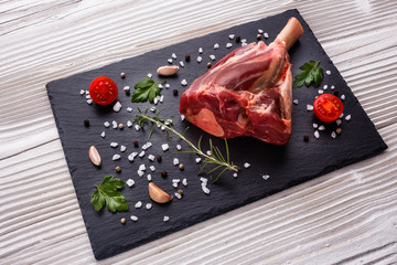 fresh lamb meat on a textured stone plate