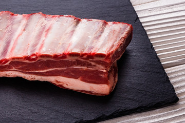 fresh lamb meat on a textured stone plate