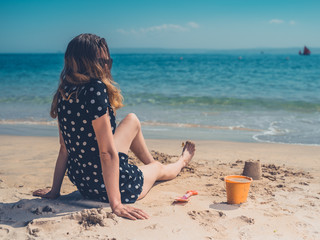 Woman on beach with bucket
