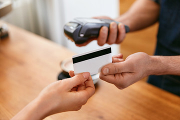 Customer Paying With Credit Card In Coffee Shop Closeup