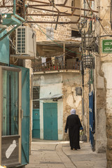 Acre, Israel - May 10, 2018 : Muslim woman walking in old Acre