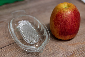 Apfel und Glas auf Holztisch