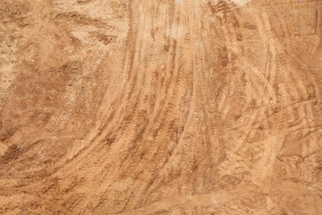 Traces of the footprints of the wheels on the sand