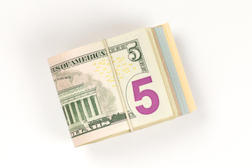 Obraz na płótnie Canvas Stack of USA 5 dollars isolated on white background.