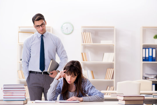 Male lecturer giving lecture to female student