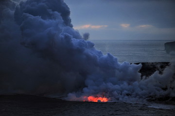 Fototapeta na wymiar The lava of Kilauea volcano flows into the Pacific Ocean