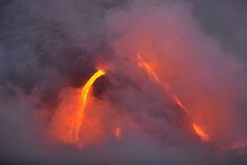 Fototapeta na wymiar The lava of Kilauea volcano flows into the Pacific Ocean
