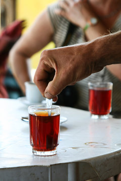 Stirring A Cup Of Tea With A Spoon