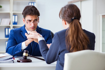 Lawyer talking to his client in office