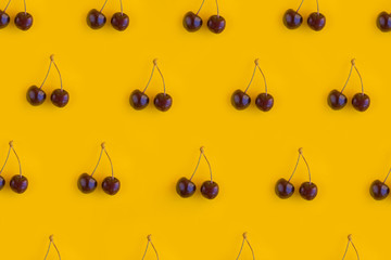 Red sweet cherry on a yellow background. Summer food