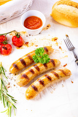 delicious bratwurst with ketchup and fresh rolls