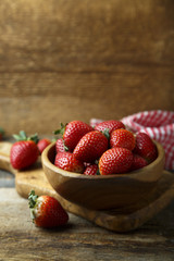 Fresh strawberry in wooden bowl