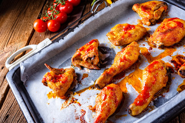 Rustic backed chicken wings,legs on baking tray