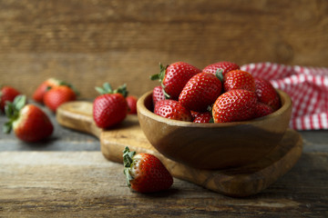 Fresh strawberry in wooden bowl