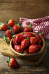 Fresh strawberry in wooden bowl