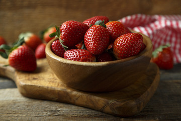 Fresh strawberry in wooden bowl