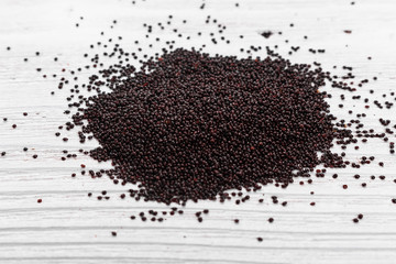 Naklejka premium fresh amaranth grains on a rustic background