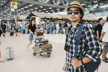 Asian man bag pack tourist with camera in airport.
