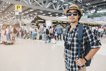 Asian man bag pack tourist with camera in airport.