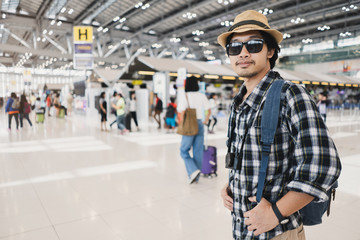 Asian man bag pack tourist with camera in airport.