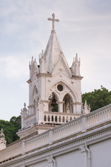 White church tower with trees on the background at twilight, Xiamen, China