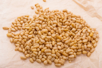 peeled pine nuts on a rustic background