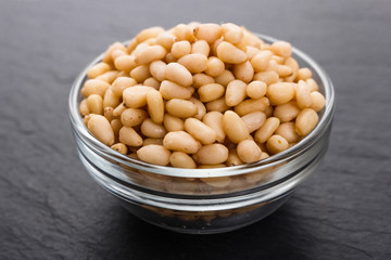 peeled pine nuts on a rustic background